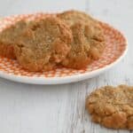A plate of golden crunchy Anzac biscuits made with rolled oats.