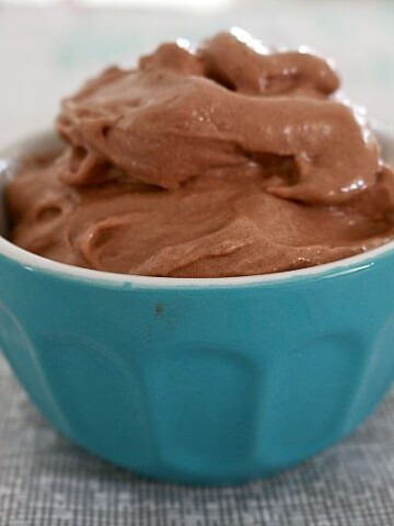 Swirls of peanut butter and chocolate ice-cream in a small blue bowl.