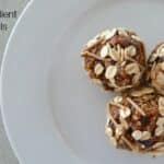 Bliss balls made with toasted muesli and dates, served on a white plate.