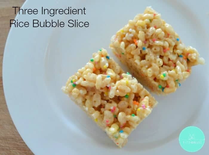 Two pieces of slice made with Rice Bubble\'s and 100\'s & 1000\'s mixed through.