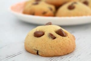 A close up of chocolate chips baked through golden cookies.