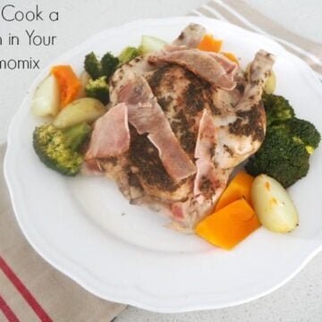Potatoes, carrots and broccoli cooked and served on a plate with a whole cooked chicken.