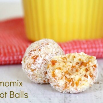 Two apricot balls rolled in desiccated coconut, with one half eaten showing texture inside.