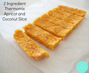 A slab of apricot and coconut slice cut into slices.