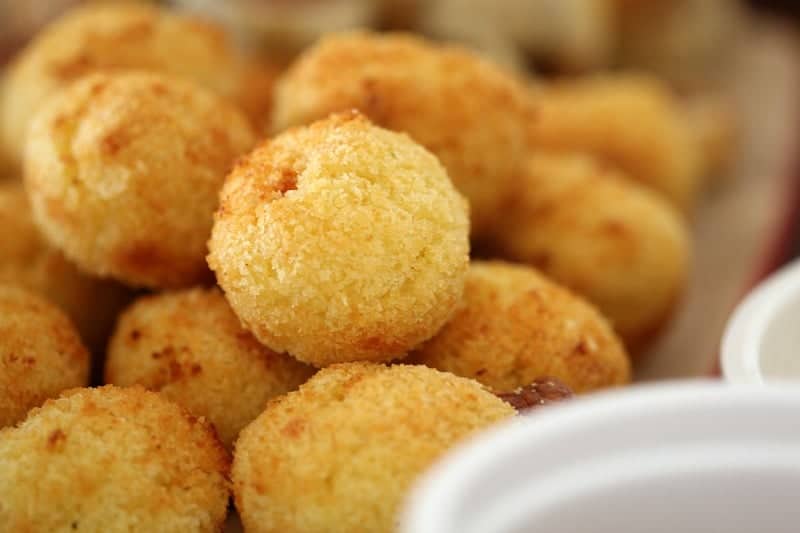 A close up of a pile of golden little arancini balls