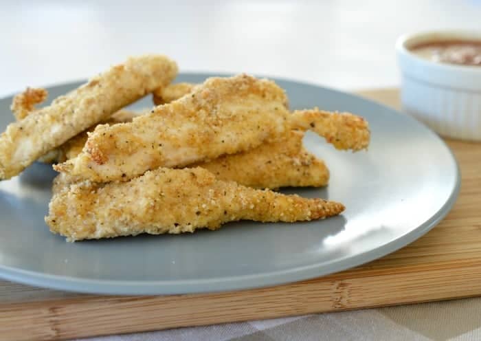 Crispy baked chicken tenders with a golden crumb coating served on a plate