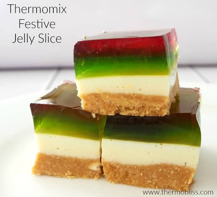Three pieces of a jelly slice with red, green and white layers on a biscuit base.