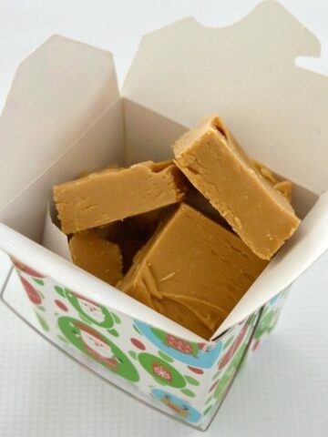 A box filled with caramel coloured fudge squares.