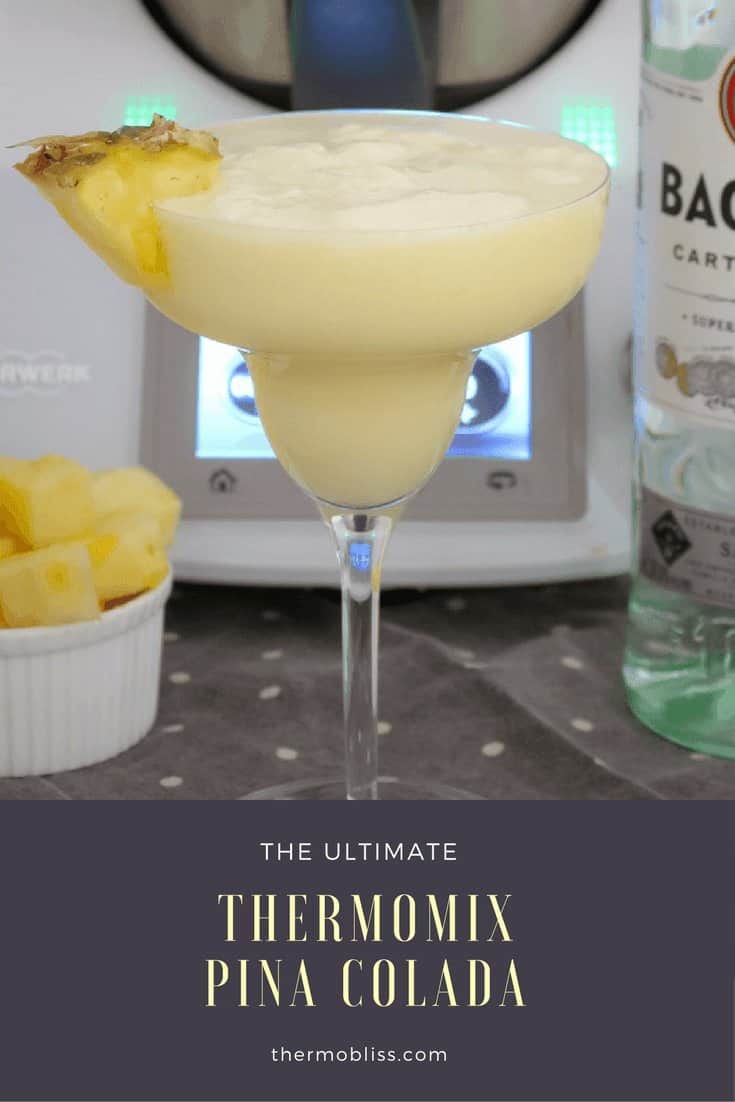A cocktail glass filled with a creamy white drink and a piece of fresh pineapple on the side of the glass.