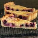 Three wedges of a lemon and blueberry tart made with shortcrust pastry.