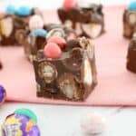 A close up of a piece of Rocky Road filled with mini Easter eggs throughout, and mini coloured Easter eggs on top.