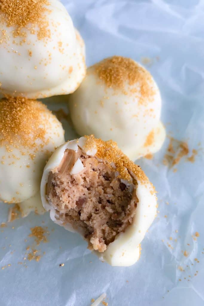 White chocolate coated balls, with one split to reveal a cheesecake type filling inside.