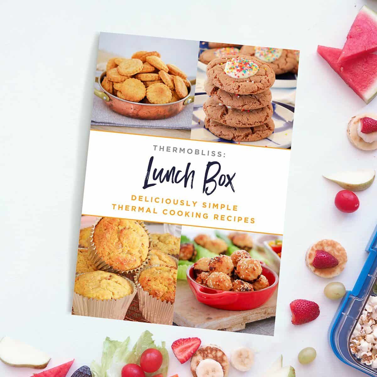 A ThermoBliss 'Lunch Box' recipe book on a bench