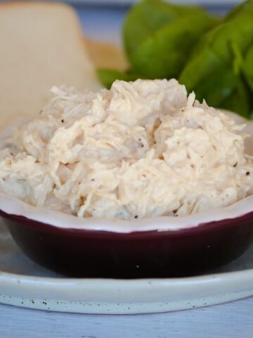 Steamed and shredded white chicken breast meat in a bowl.