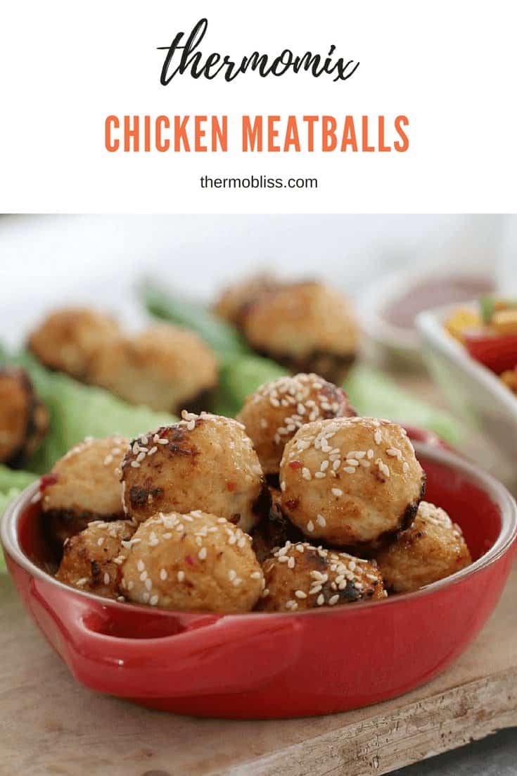 A red ramekin filled with Chicken meatballs. 