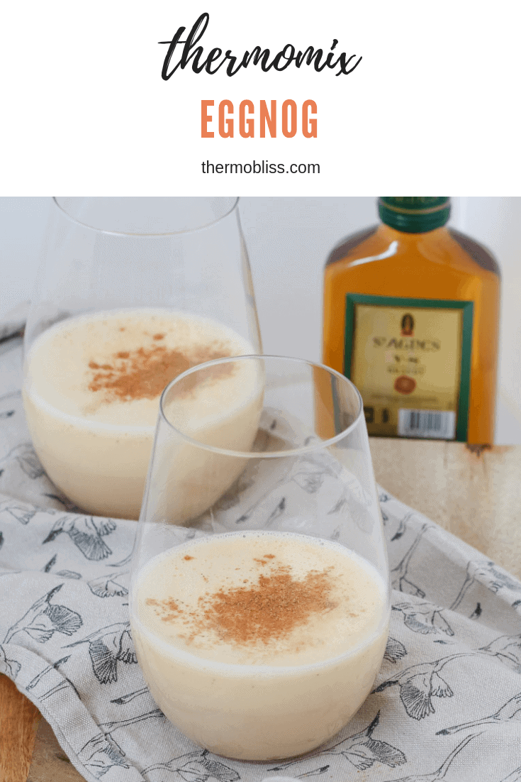 A glass filled with creamy liquid and sprinkled with nutmeg.