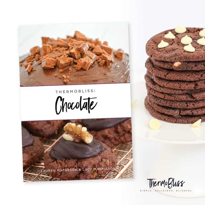 The cover of a recipe book with text Thermomix Chocolate, next to a stack of double chocolate cookies