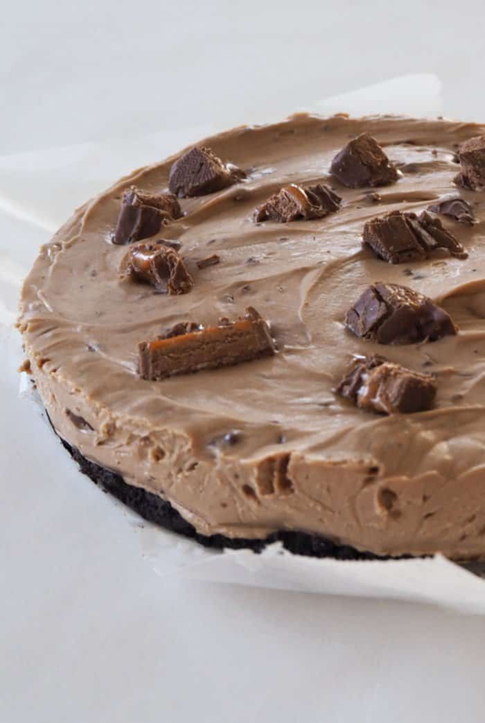A chocolate cheesecake with chunks of Mars Bars on top