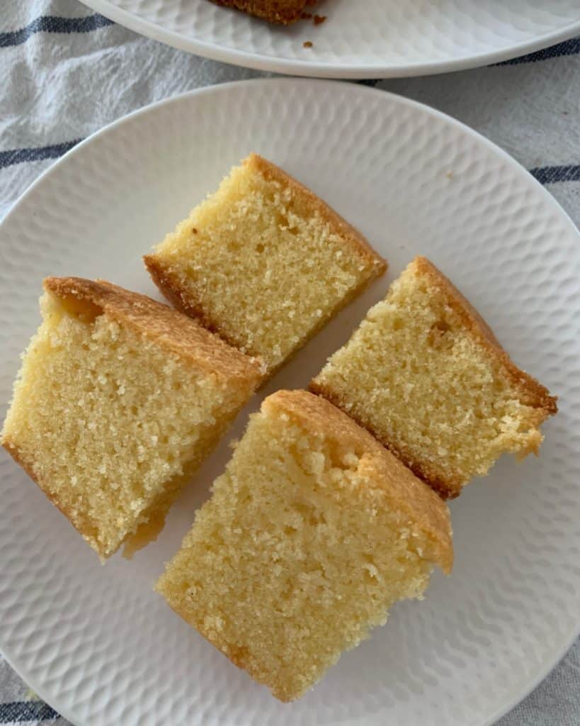 An overhead shot of four pieces of pound cake cut and served on a plate
