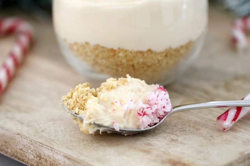 A spoonful of cheesecake mixture with crushed candy canes.