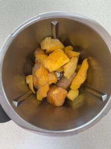 Frozen mango and banana pieces in Thermomix bowl.