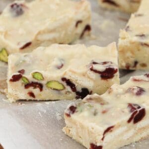 Pieces of white chocolate slice with pistachios and cranberries.