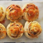 close up of cheese and vegemite scrolls on platter