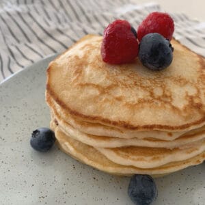 Pancake stack on plate with berries