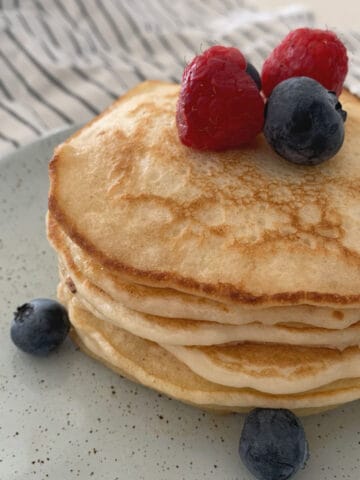 Pancake stack on plate with berries