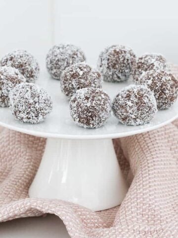 A plate of coconut balls made with cocoa, biscuits and sweetened condensed milk.
