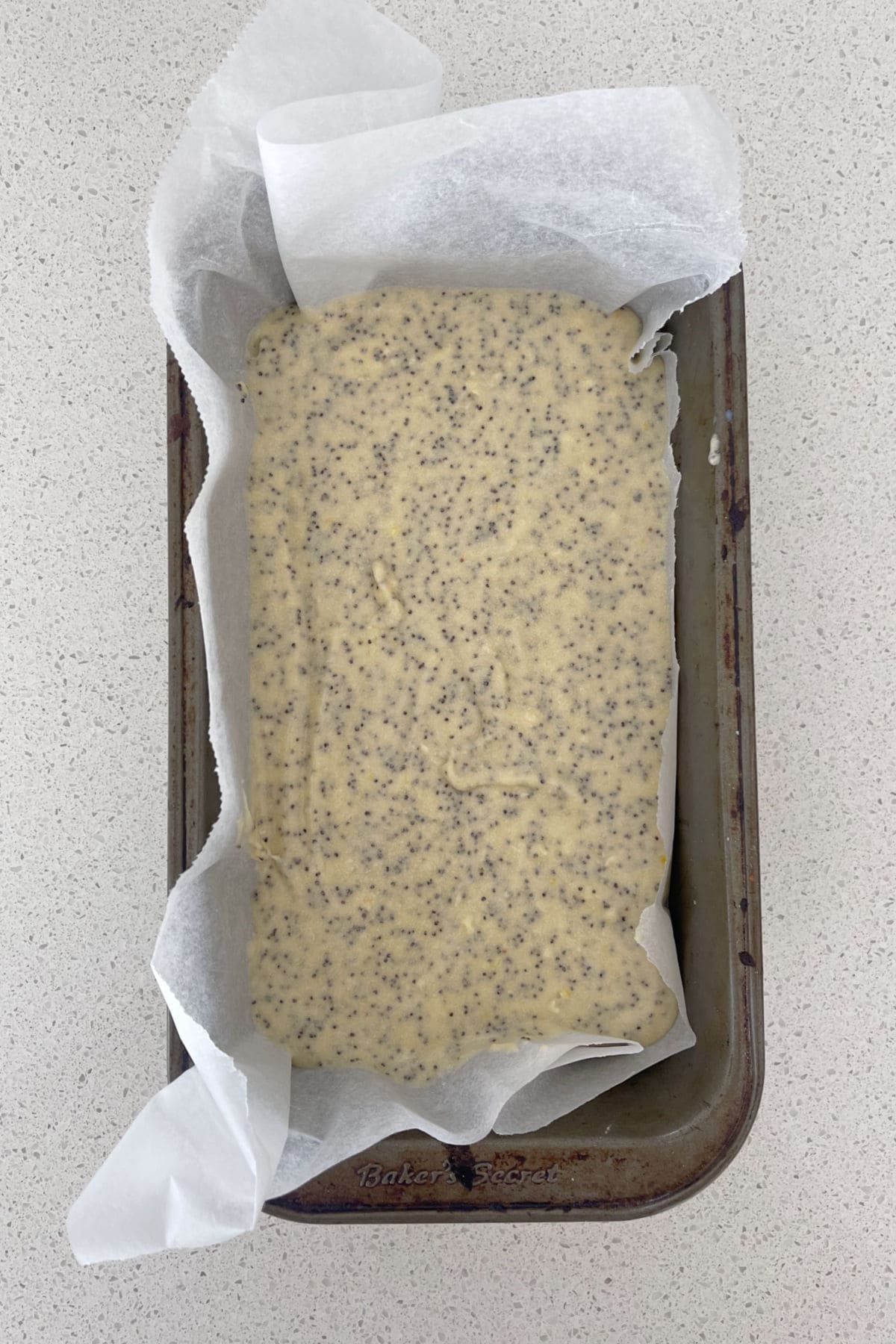 Lemon and Poppy Seed cake mixture in a baking dish.