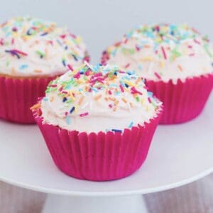 Vanilla Cupcakes on a cake stand.