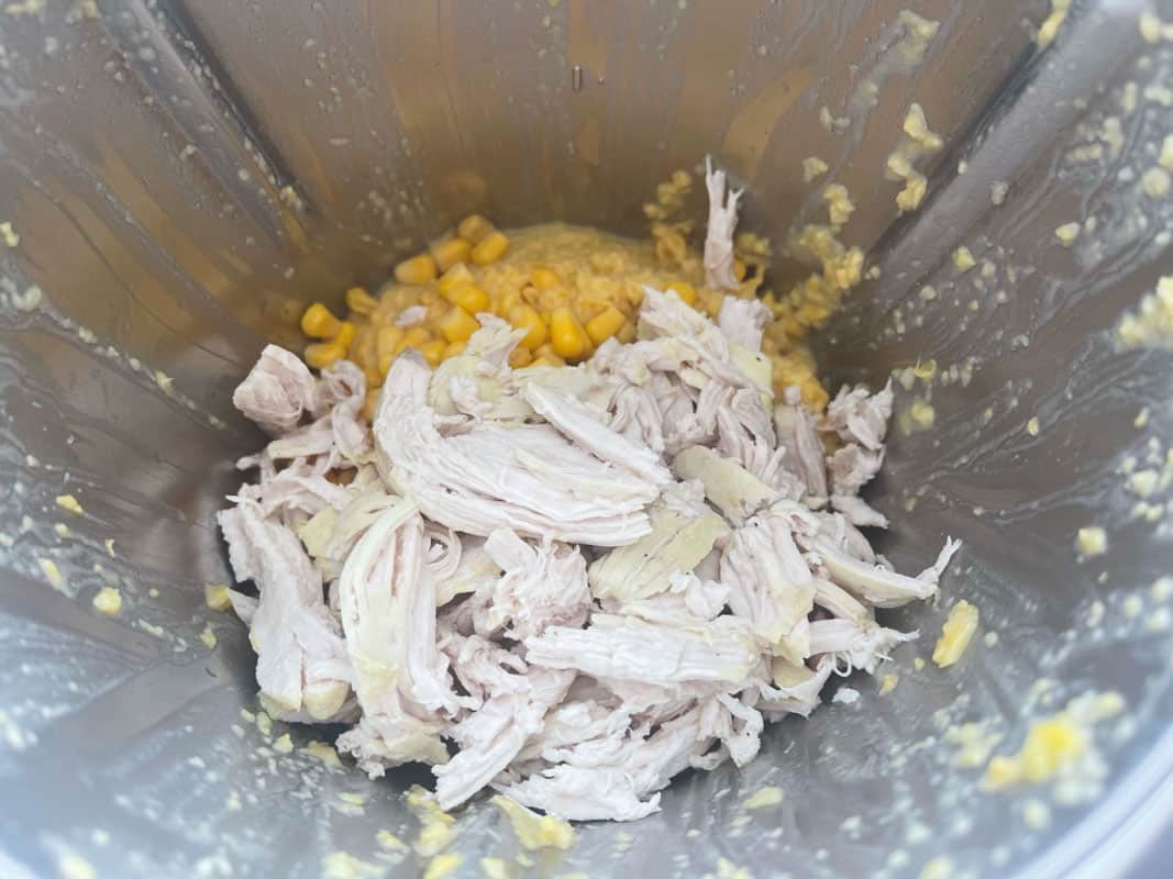 Shredded chicken and corn kernals in a Thermomix.