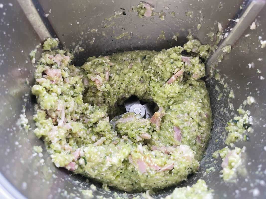 Bacon and zucchini mixture grated in a Thermomix.