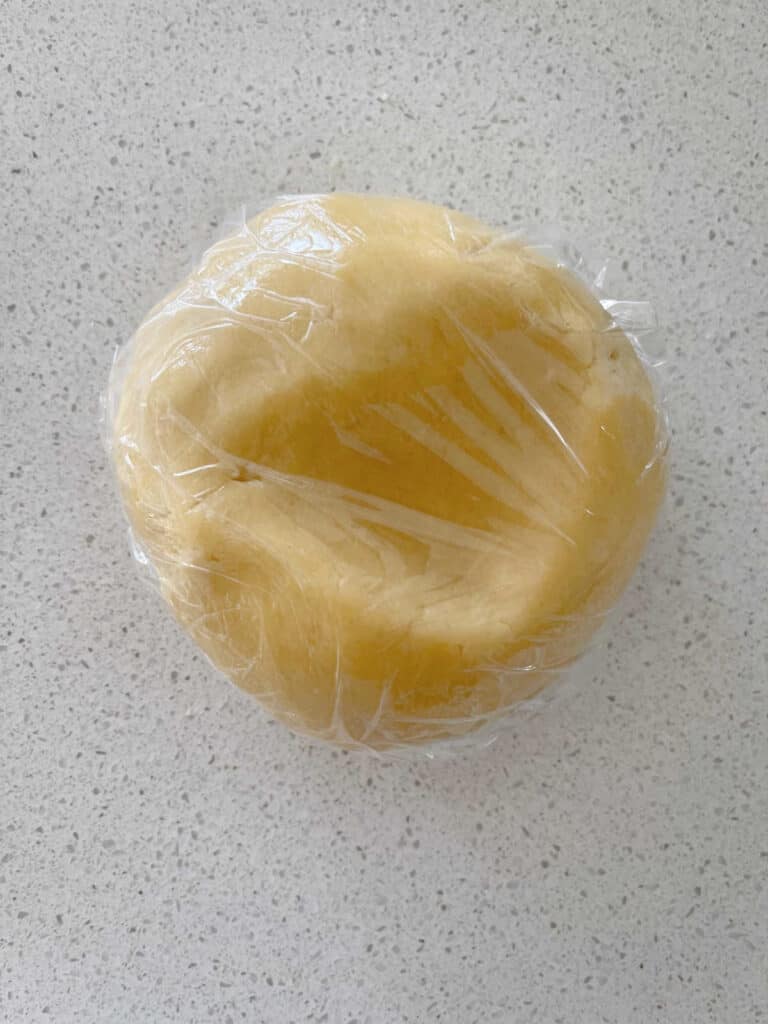 Sweet shortcrust pastry wrapped in cling wrap