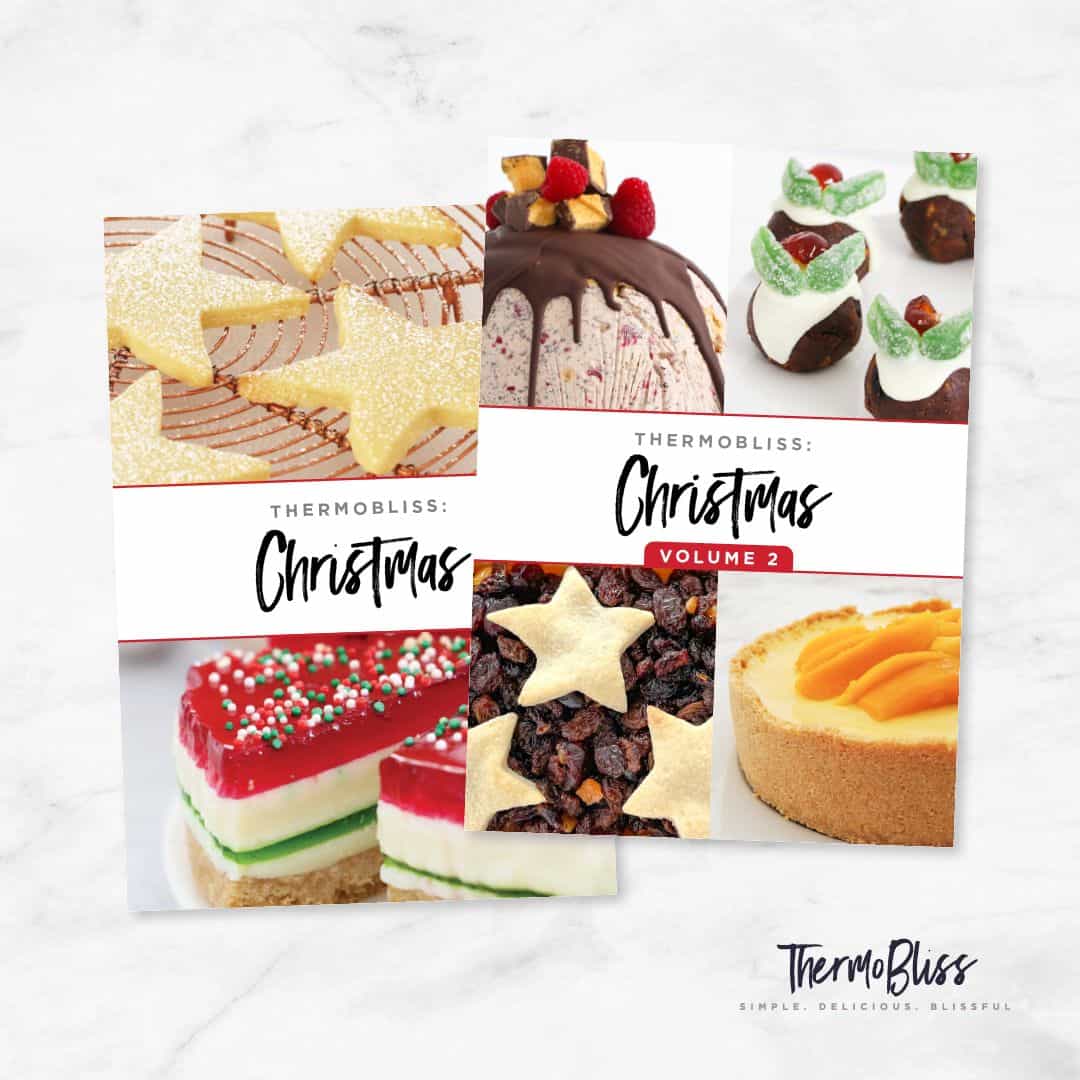 Image of ThermoBliss Christmas Cookbooks Volumes 1 and 2 on a marble background.