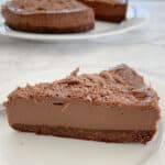 side view of a slice of nutella cheesecake on a white plate