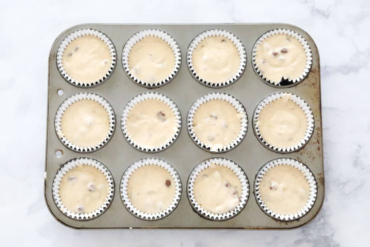 Chocolate chip banana muffin mixture in a muffin tray.