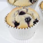 Blueberry muffins in silver paper cases.