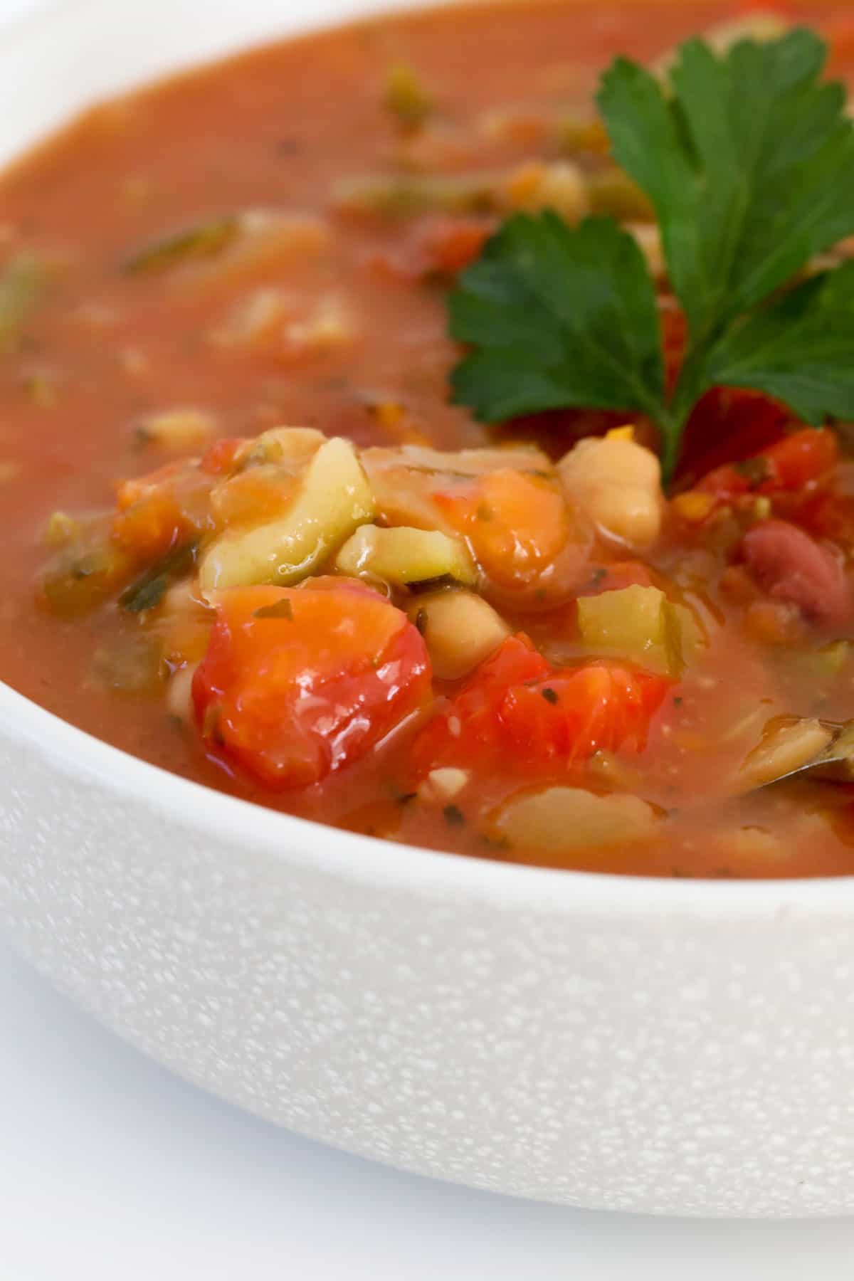 Beans and vegetables in a tomato based soup.
