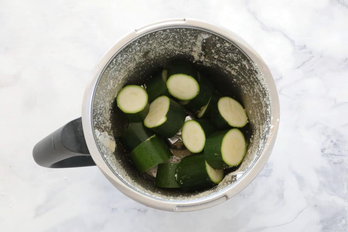 Zucchini chunks in a stainless jug.