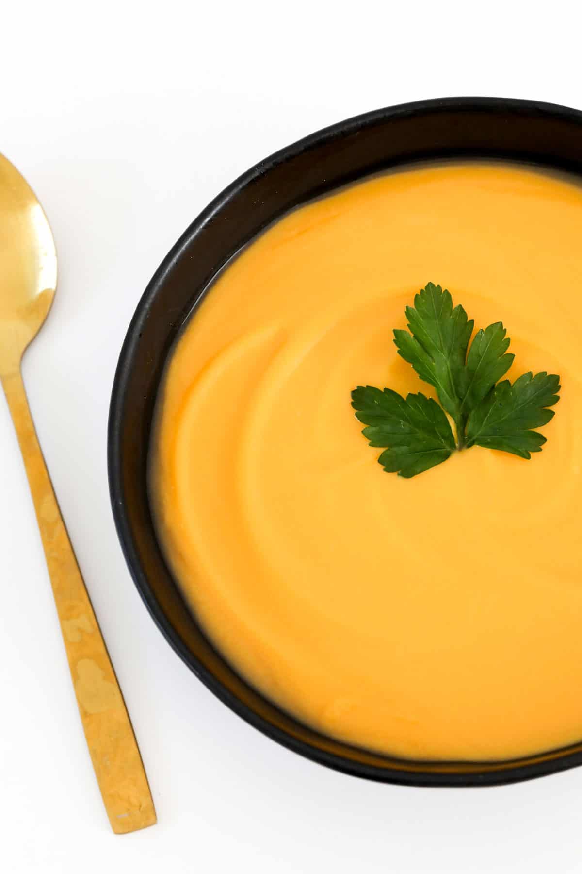 A bowl of creamy yellow soup.