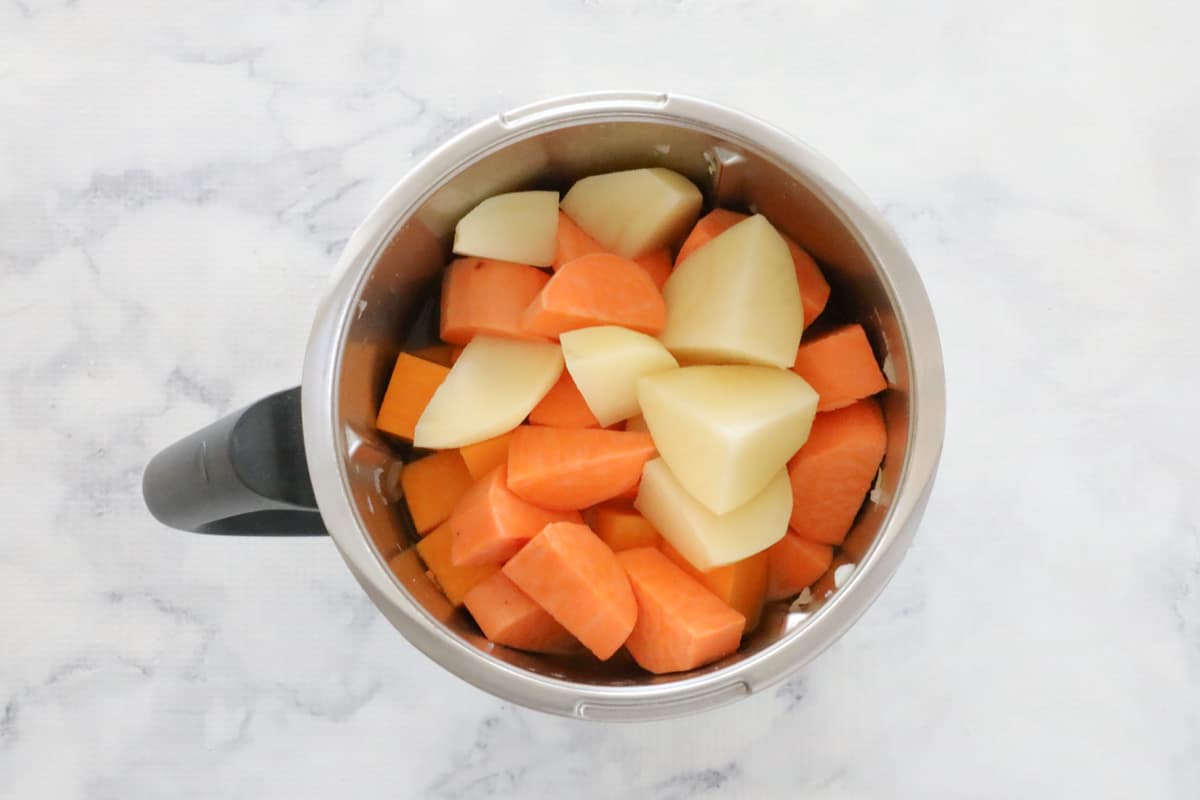 Chopped vegetables in a stainless jug.