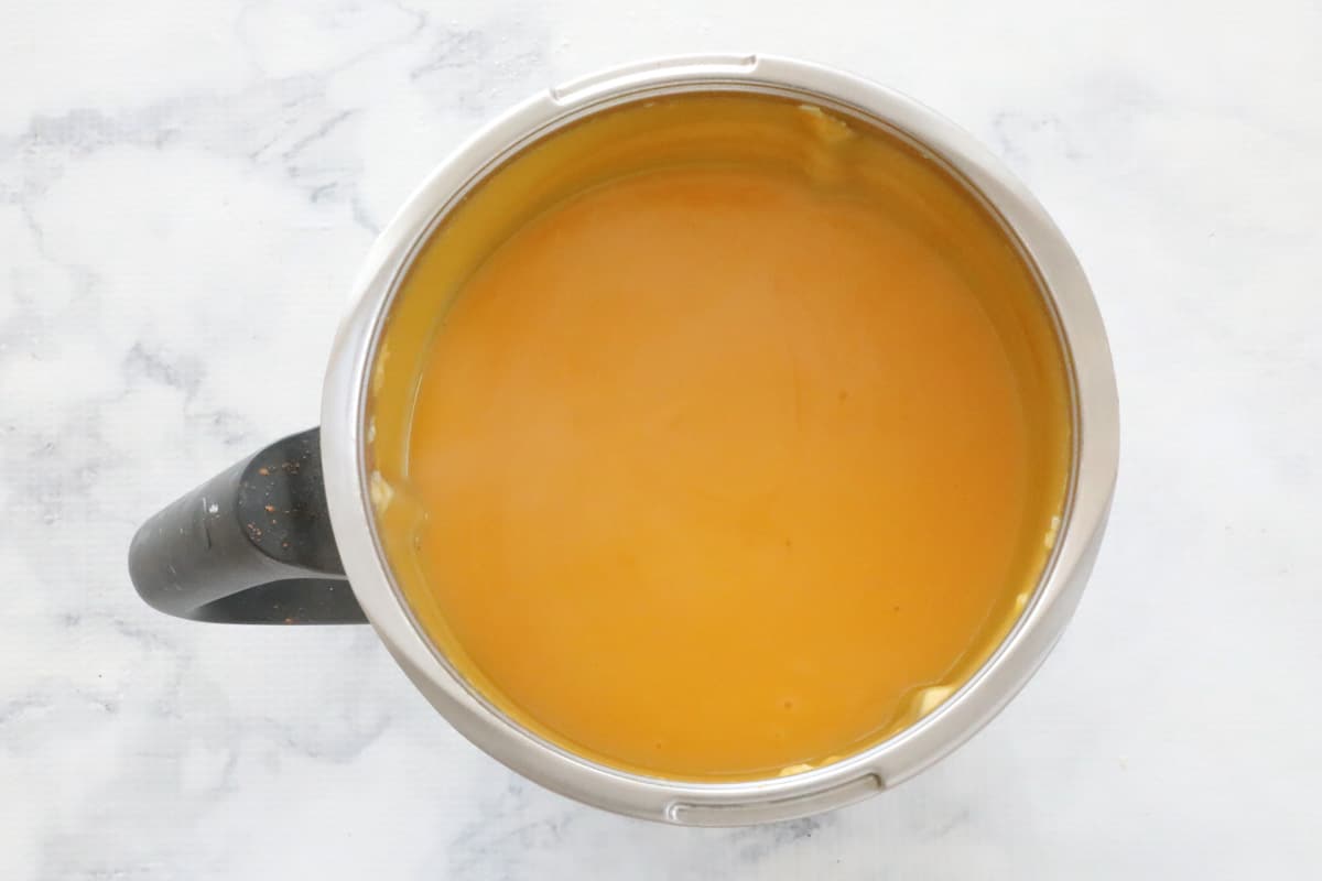 A creamy pumpkin and sweet potato soup in a jug.