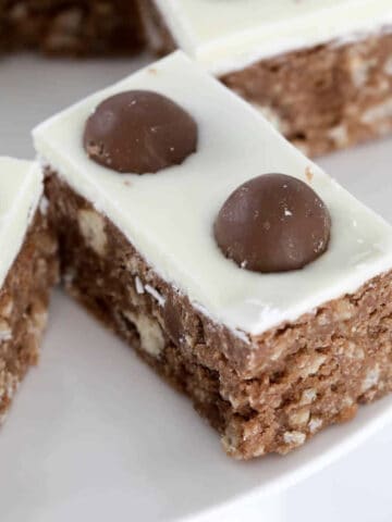 Maltesers on top of a white chocolate topped slice.