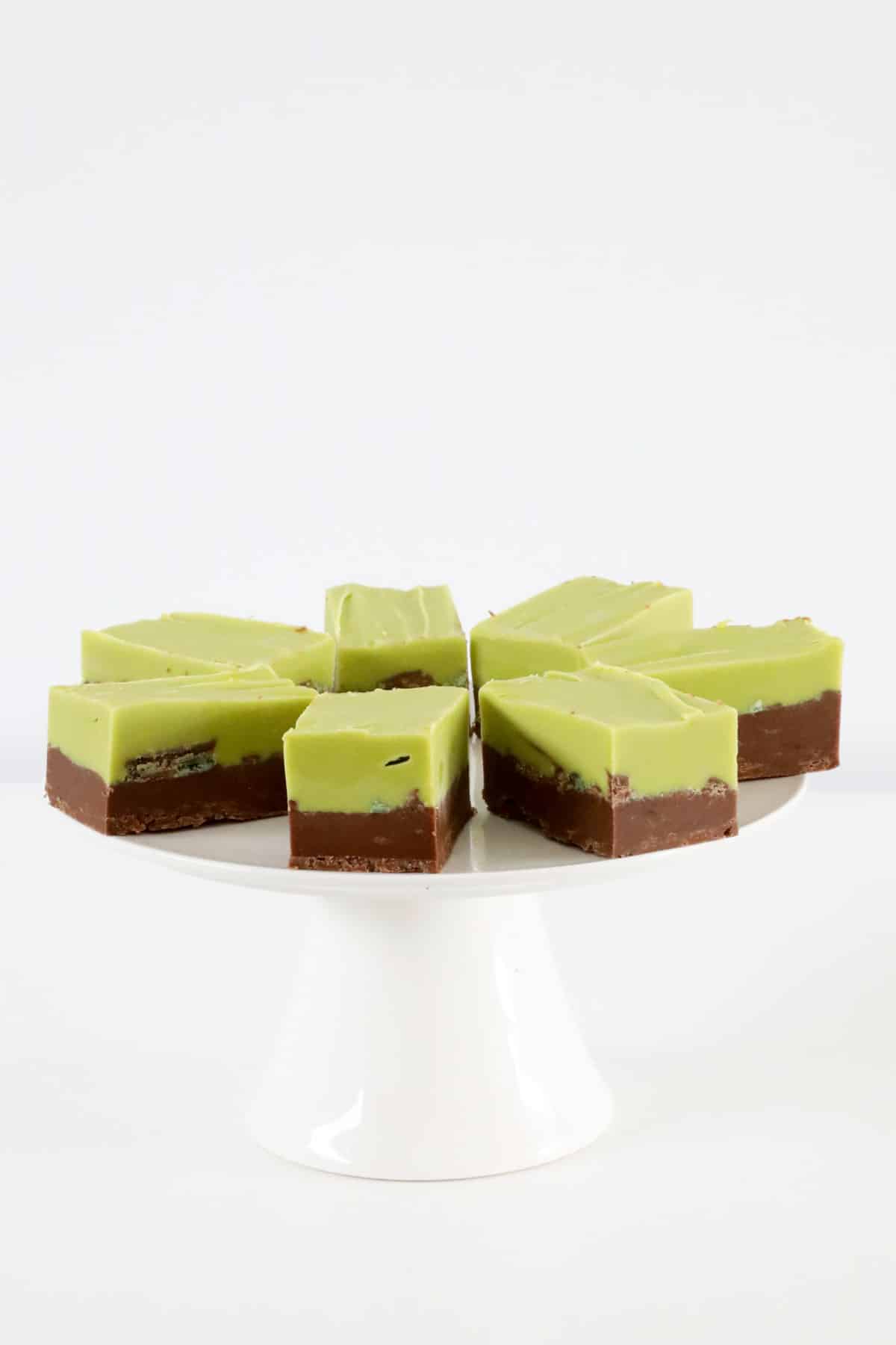 A cake plate topped with green and brown layered fudge.
