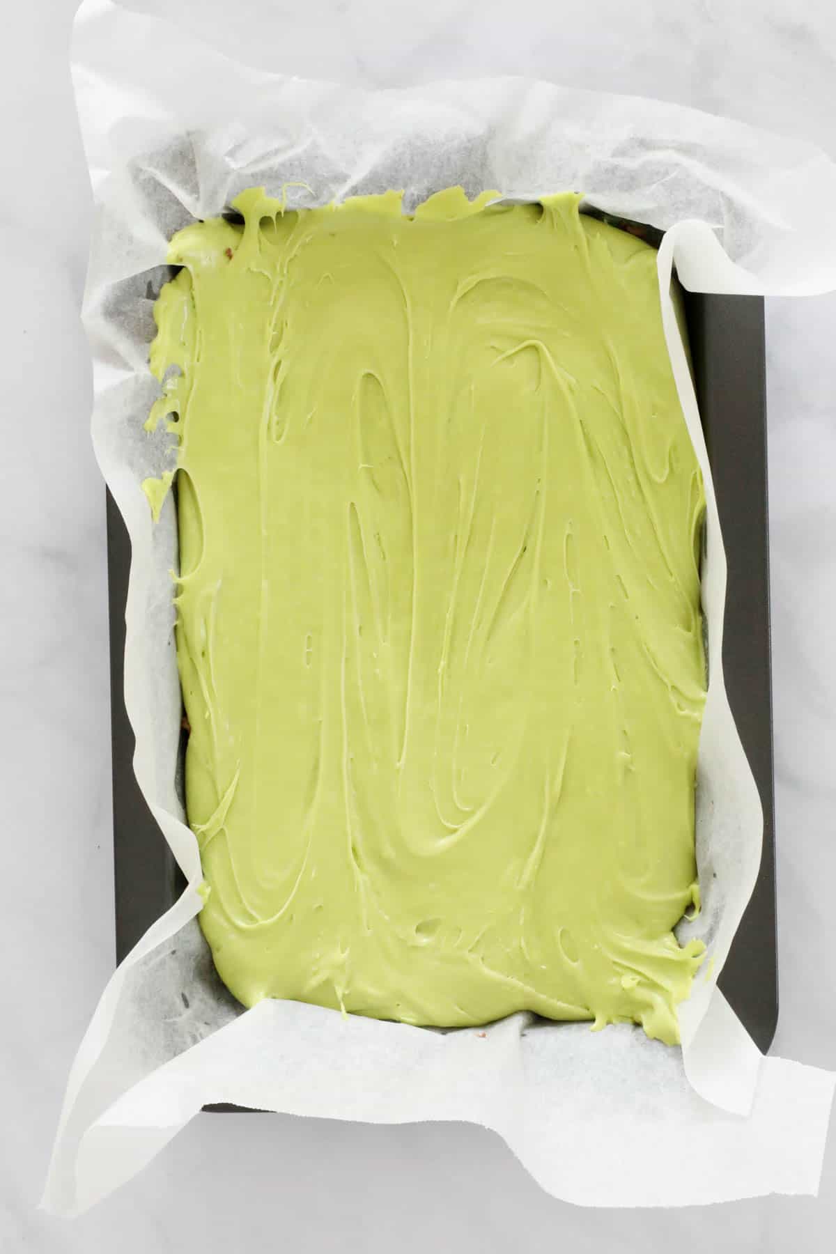 Green mint fudge in a baking tray.
