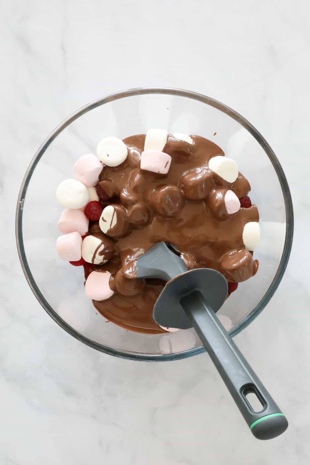 Melted chocolate in a bowl with marshmallows.