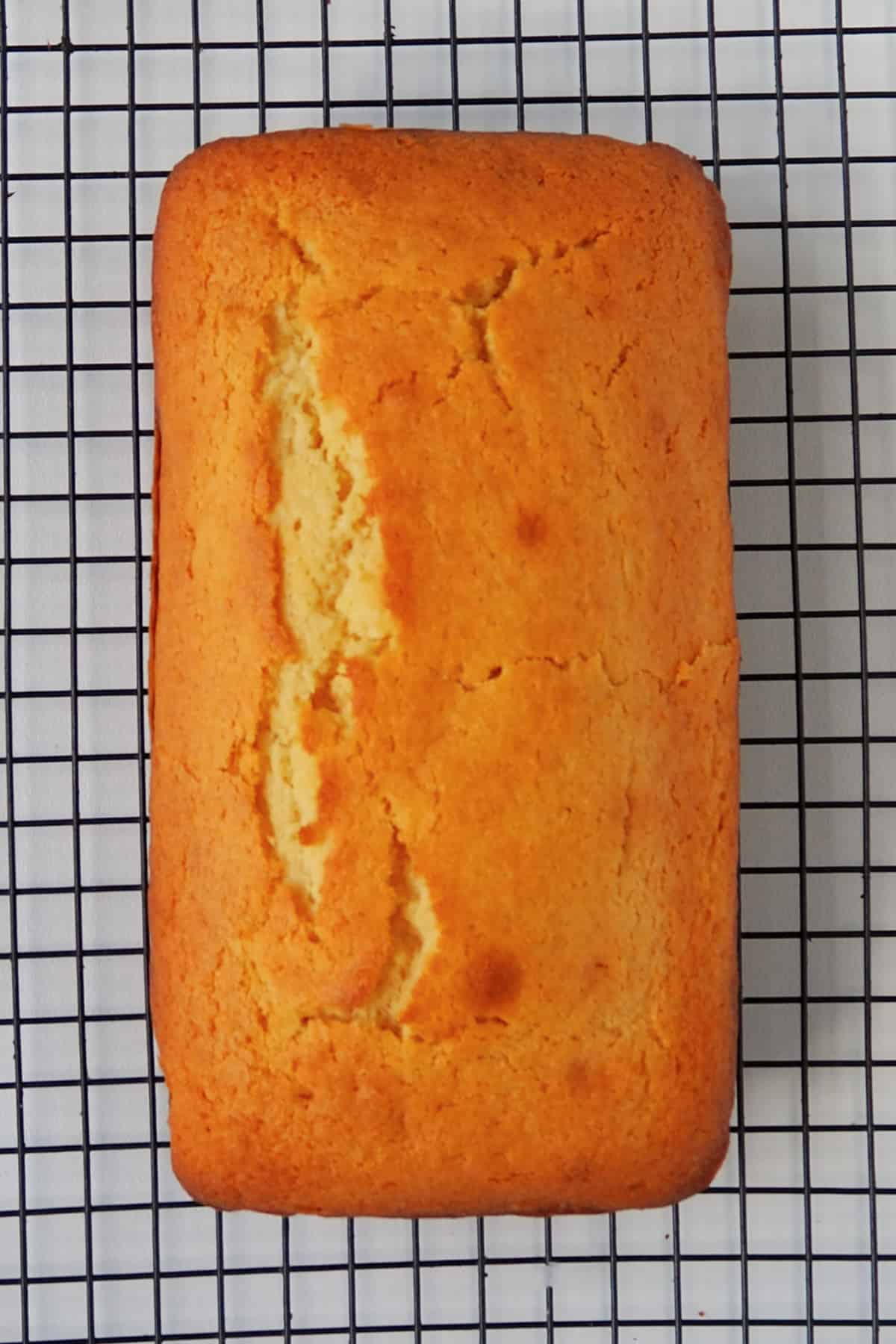 Thermomix Orange Butter Cake cooling on a wire rack.