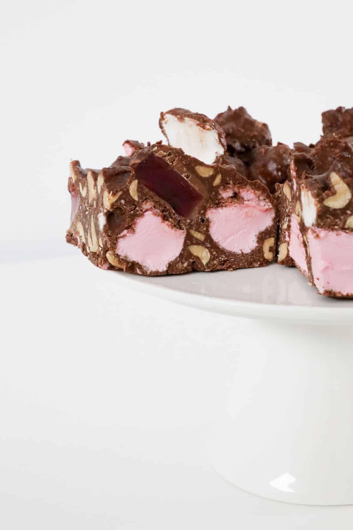 Turkish delight rocky road on a white cake stand.